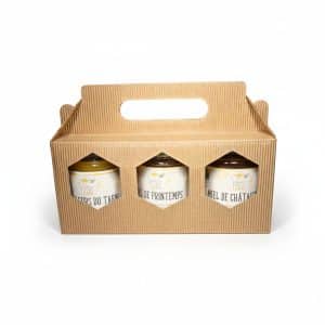 Coffret en carton avec 3 pots de miel de 250g, produits par les Ruchers du Tigou